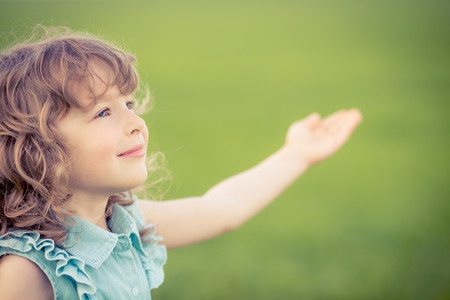 37128336 - happy child relaxing outdoors in spring filed