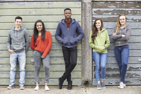 46289639 - gang of teenagers hanging out in urban environment